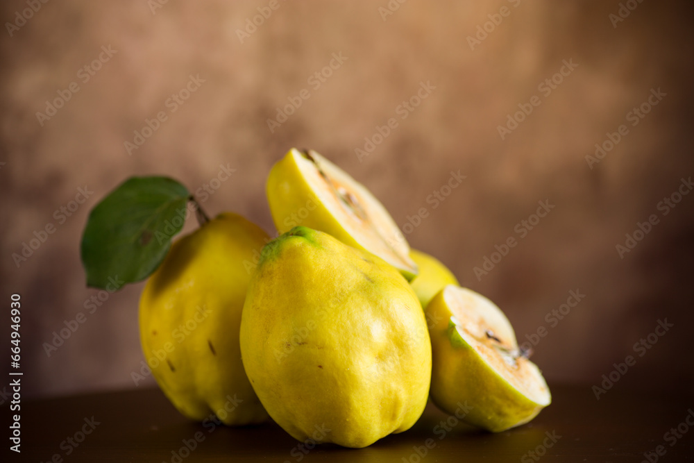 Ripe natural autumn quince on wooden table.