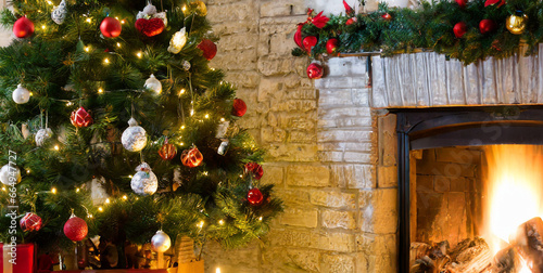 room with firepplace a christmas tree and presents under the tree decoration tree with candl  photo