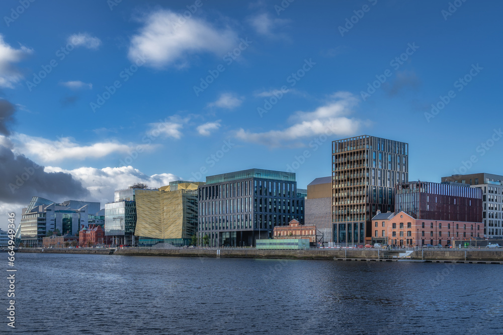 Row of modern building and old ones converted to modern architecture on N Wall Quay on the bank of Liffey River in Dublin docklands, Ireland