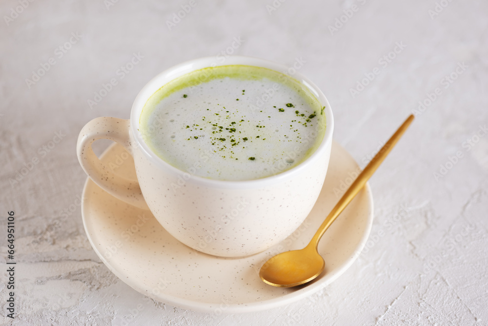 Vegan green matcha latte drink with coconut milk in a cup. Healthy drink, lactose, gluten and sugar free. Vegan green matcha latte drink with coconut milk in a cup. Healthy drink, lactose, gluten and sugar free.