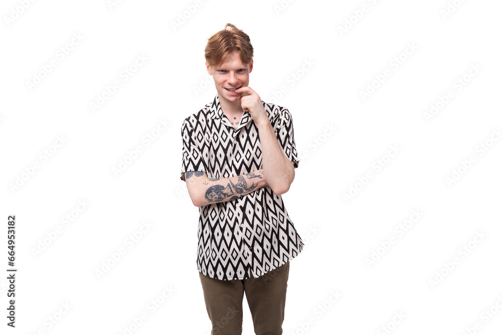 young red-haired man in a rhombus print summer shirt is brainstorming young red-haired man in a rhombus print summer shirt is brainstorming
