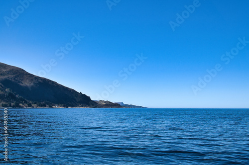 Fjord with mountains at west cape overlooking open sea. Landscape photo