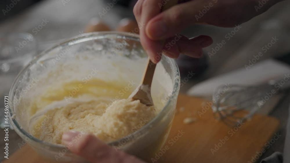 Bowl with dough on table during baking. Female hands holding bowl, mixing ingredients. Chef is preparing homemade dessert. Baker kneads dough using spoon. Traditional home cooking, woman prepar dough Bowl with dough on table during baking. Female hands holding bowl, mixing ingredients. Chef is preparing homemade dessert. Baker kneads dough using spoon. Traditional home cooking, woman prepar dough
