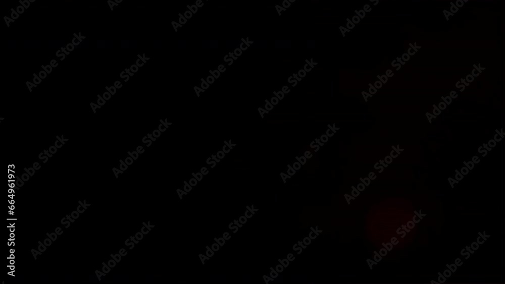 Real lens flare from leakage of cyclically blinking bright red light with bokeh circles, on the right of frame on black background for overlay.