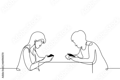 man and a woman are sitting at the table opposite each other with their heads buried in their phones - one line art vector. concept obsession with social networks, addiction to phone