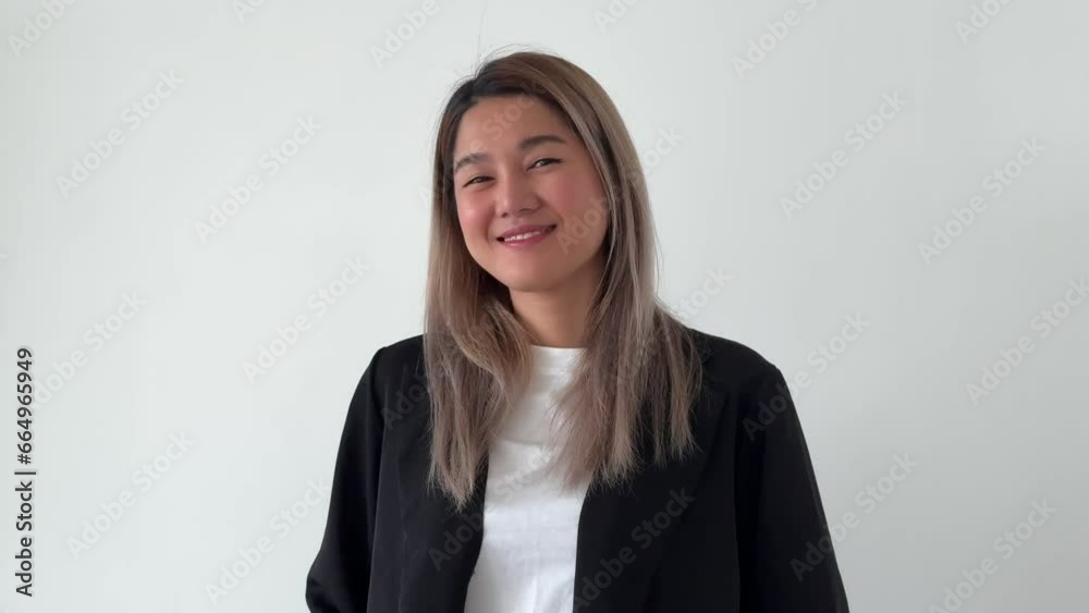 Happy smile face of asian business secretary woman in casual suit stand on white wall. Happy smile face of asian business secretary woman in casual suit stand on white wall.