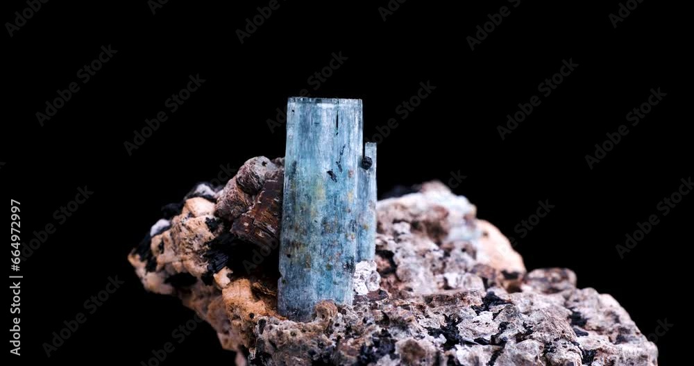 blue aquamarine with schorl (black tourmaline) inclusion rotating 360° in 4k isolated on black background. macro detail close-up rough raw unpolished semi-precious gemstone.
blue aquamarine with schorl (black tourmaline) inclusion rotating 360° in 4k isolated on black background. macro detail close-up rough raw unpolished semi-precious gemstone.