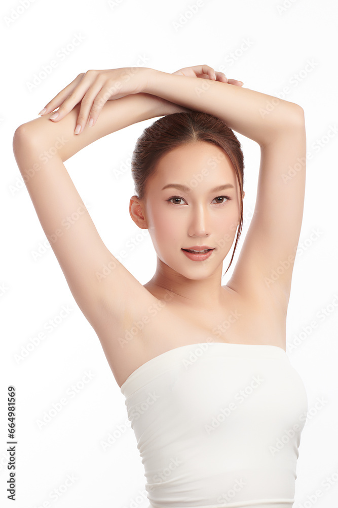 Beautiful Young Asian woman lifting hands up to show off clean and hygienic armpits or underarms on white background, Smooth armpit cleanliness and protection concept