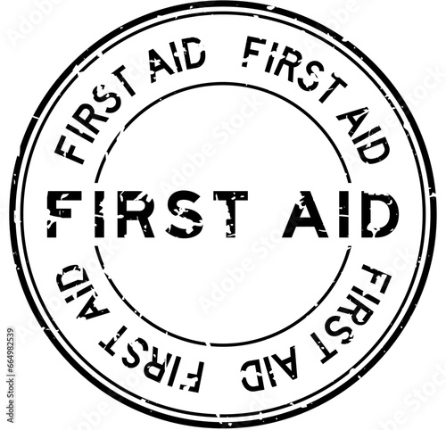 Grunge black first aid word round rubber seal stamp on white background