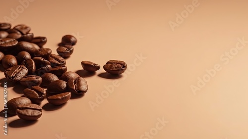 Coffee beans isolated on left side of light brown background with empty space photo