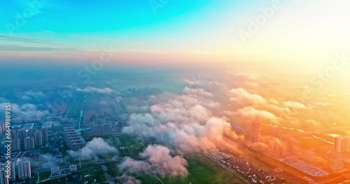 Aerial view of beautiful sky clouds and residential area buildings landscape at sunrise in Jiashan County, Jiaxing, Zhejiang Province, China. photo