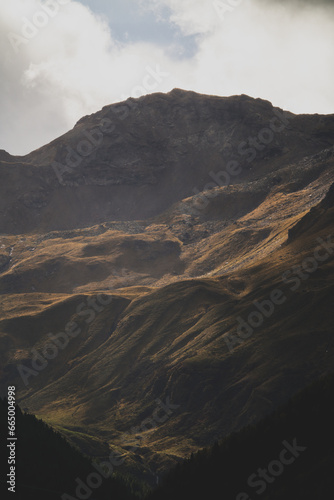 mystical autumnal colors on the mountains, the hohe tauern in austria, at a windy day with south foehn