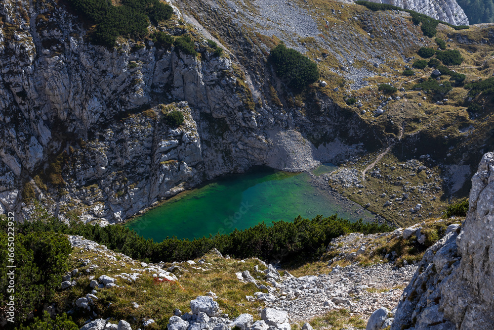 Obraz premium Lower Alpine Lake of Kriški Podi, the highest situated lakes in Slovenia. It is a glacial lake in Julian Alps.