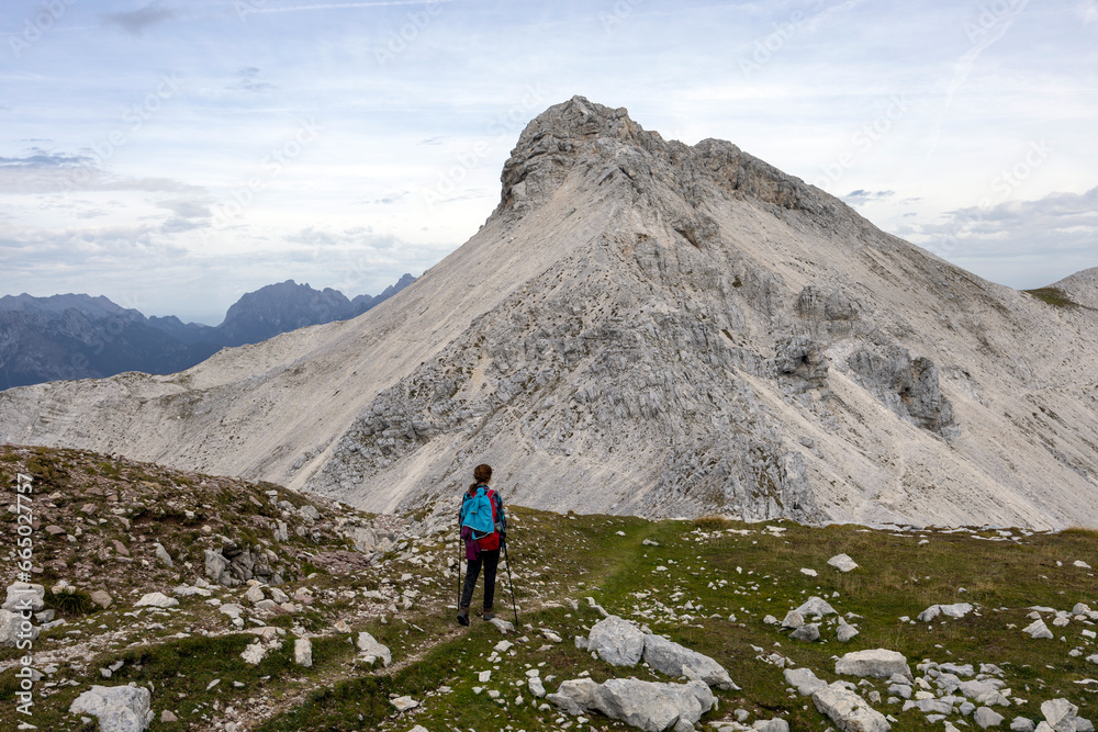 Adult Woman Hiker Hike Between Krn and Batognica Mountain on a very scenic Alpine trail in Julian Alps - Slovenia