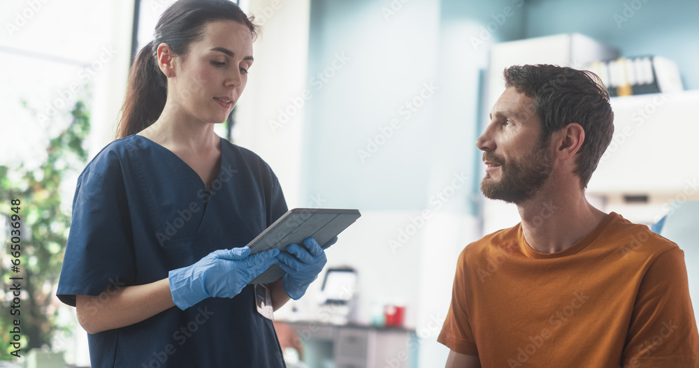 Obraz premium Caucasian Man Sitting In The Chair In Bright Public Hospital And Listening To Female Nurse With Tablet Computer. Professional Woman Explaining Possible Side Effects After Medicine Injection.