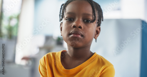 Obraz na płótnie Portrait Of Young African American Boy Sitting In The Chair In Hospital, Looking At Camera