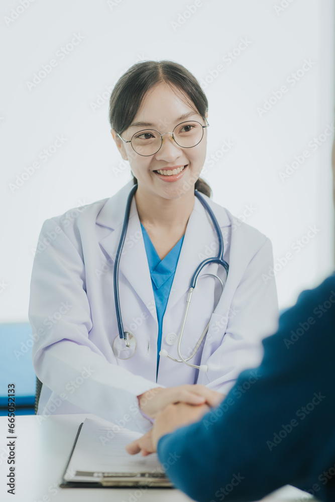 Professional female doctor smiles and shows positive test results to elderly male patient at doctor's appointment in modern office of medical institution Professional female doctor smiles and shows positive test results to elderly male patient at doctor's appointment in modern office of medical institution