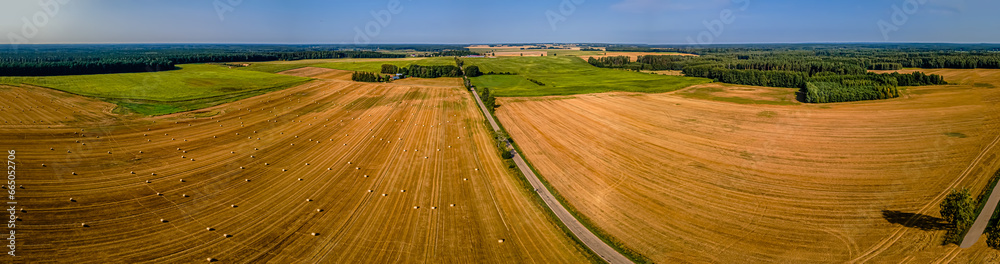 Aerial panorama of farmland with bales of straw on a sunny,summer day in Podlasie.