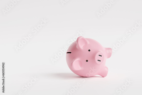 Pink piggy bank lying down on white background. Illustration of the concept of loss in investment and bankruptcy