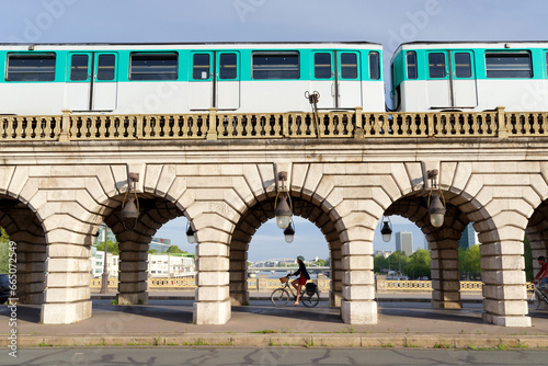 Photography Subway train and cyclist on the Bercy bridge in Paris city