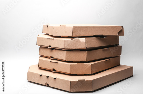 Stack of pizza cardboard boxes on gray background