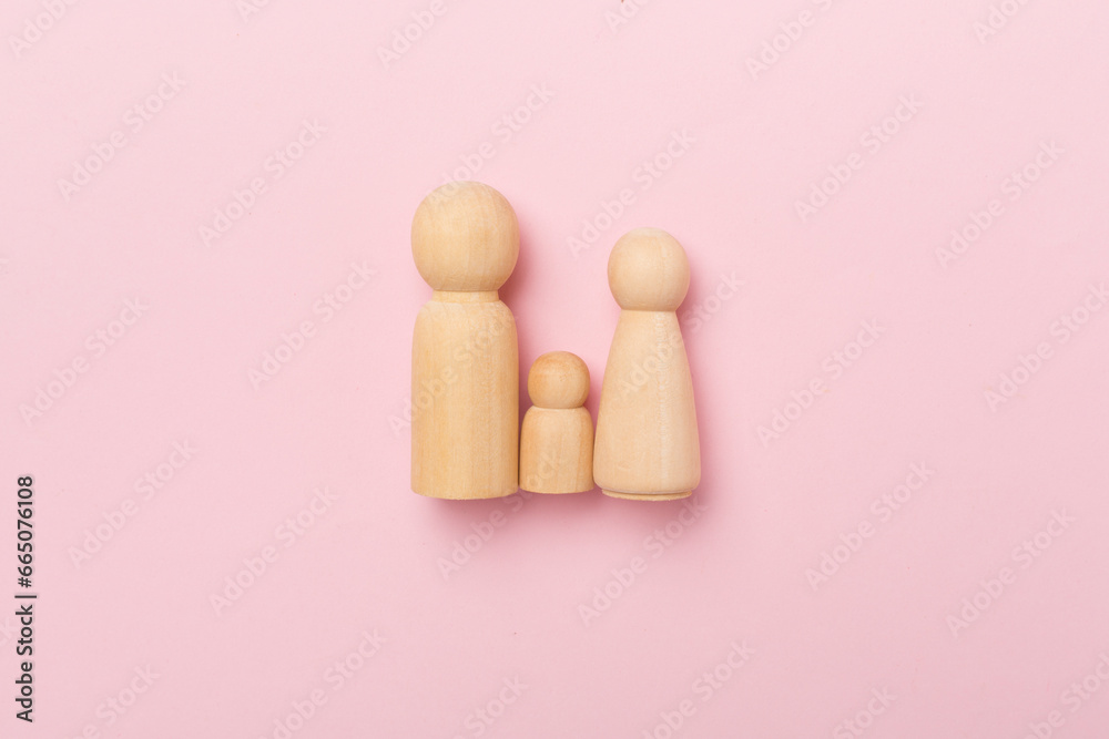 Wooden family figures on color background, top view Wooden family figures on color background, top view