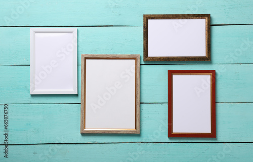 Blank wall frames on blue wooden background