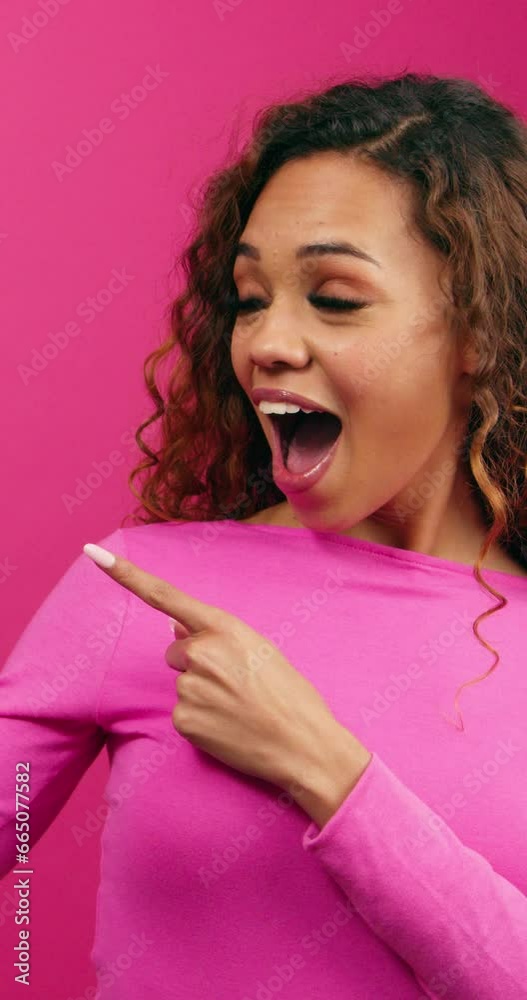 Smiling young women points two fingers to copy space, Valentine's Day promotion Smiling young women points two fingers to copy space, Valentine's Day promotion