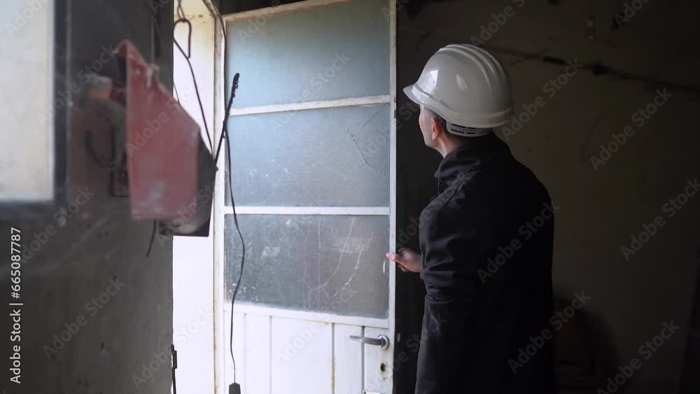Home Inspector Checking Door With Broken Glass Panel. House Renovation. medium shot Home Inspector Checking Door With Broken Glass Panel. House Renovation. medium shot