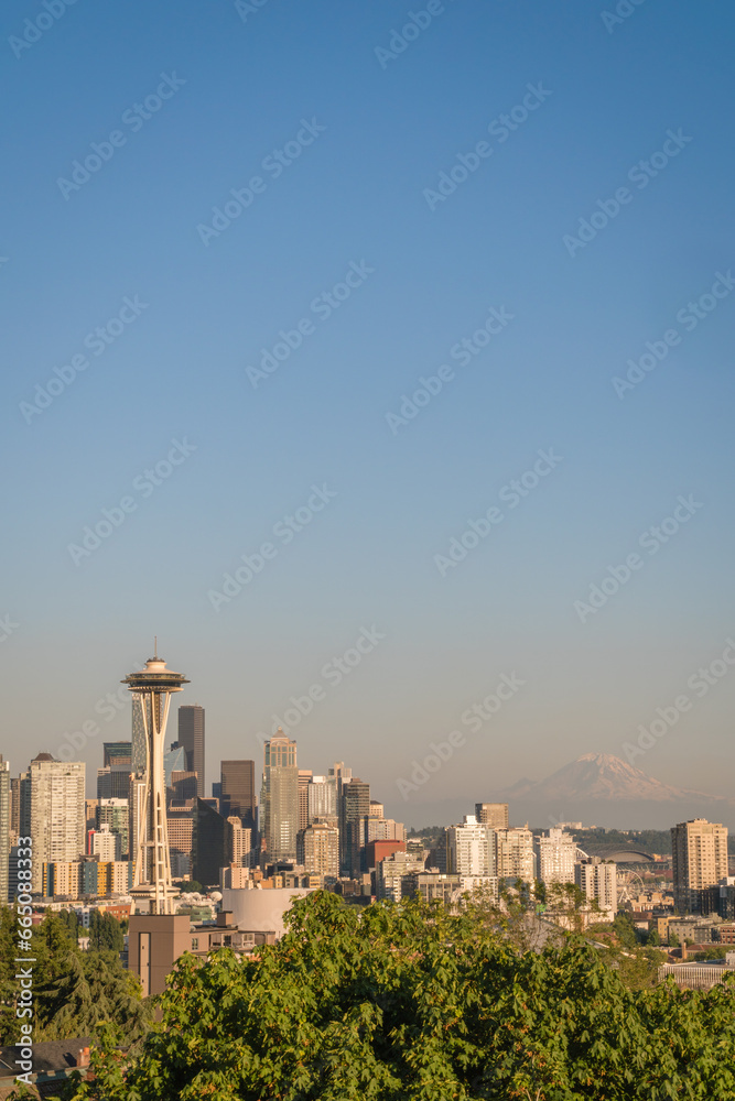 The skyline of Seattle, Washington, USA with the Space Needle observation tower and Mt. Ranier in the background on a sunny day
