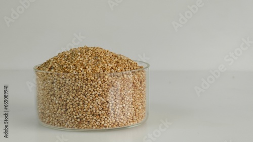 Closeup of kodo millet, a healthy grain, in a glass bowl filled to the brim, highlighting their wholesome and nutritious appeal. photo