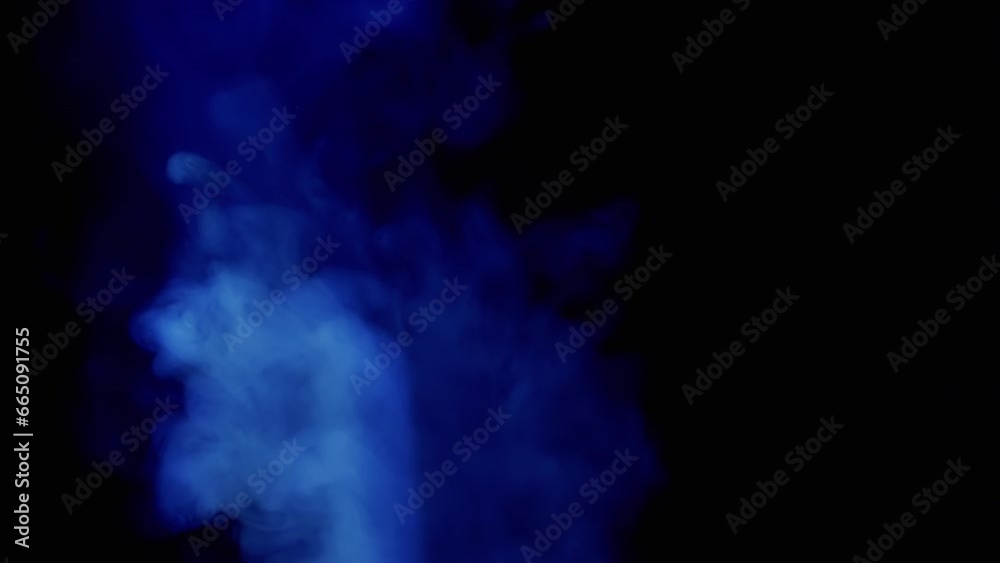 Thick Blue Clouds of Smoke on an Isolated Black Background Fall in Empty Space. Side view. Texture. Slow motion of a flying cloud of smoke, cold fog, smog. Ice cloud. Smoking a hookah, cigarette. Thick Blue Clouds of Smoke on an Isolated Black Background Fall in Empty Space. Side view. Texture. Slow motion of a flying cloud of smoke, cold fog, smog. Ice cloud. Smoking a hookah, cigarette.