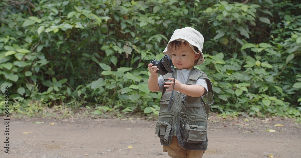 Happy Tourist cute little Asian toddler daughter kid girl using binoculars watching animals in the forest natural background, adventure explorer camping travel trip Learning about Nature Happy Tourist cute little Asian toddler daughter kid girl using binoculars watching animals in the forest natural background, adventure explorer camping travel trip Learning about Nature