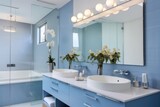 A modern bathroom with double sinks and a spacious mirror