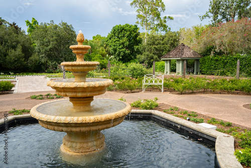 A Garden with a Fountain, a Bench and a Gazebo.