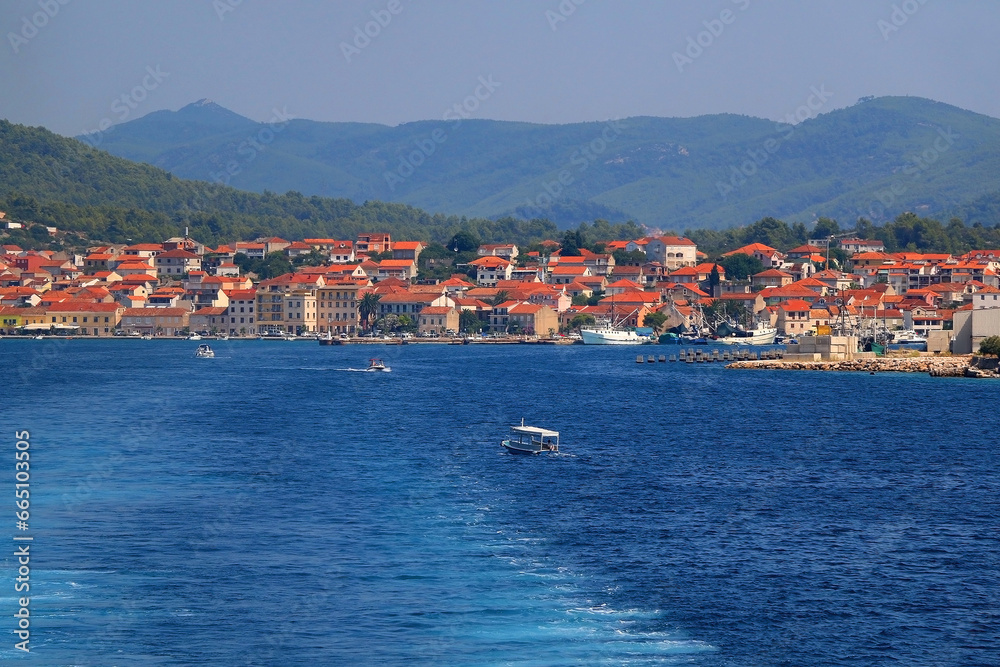 Small rustic boat on the promenade. Picturesque scene from Croatia.