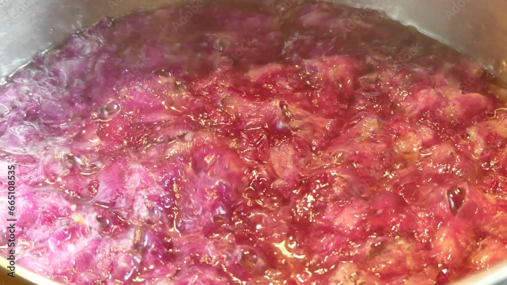 Cooking petals of flowers Peony and Roses in water with sugar in metal pot for homemade jam - real time. Topics: natural vitamins, cooking, diet, health, natural medicine, season Cooking petals of flowers Peony and Roses in water with sugar in metal pot for homemade jam - real time. Topics: natural vitamins, cooking, diet, health, natural medicine, season
