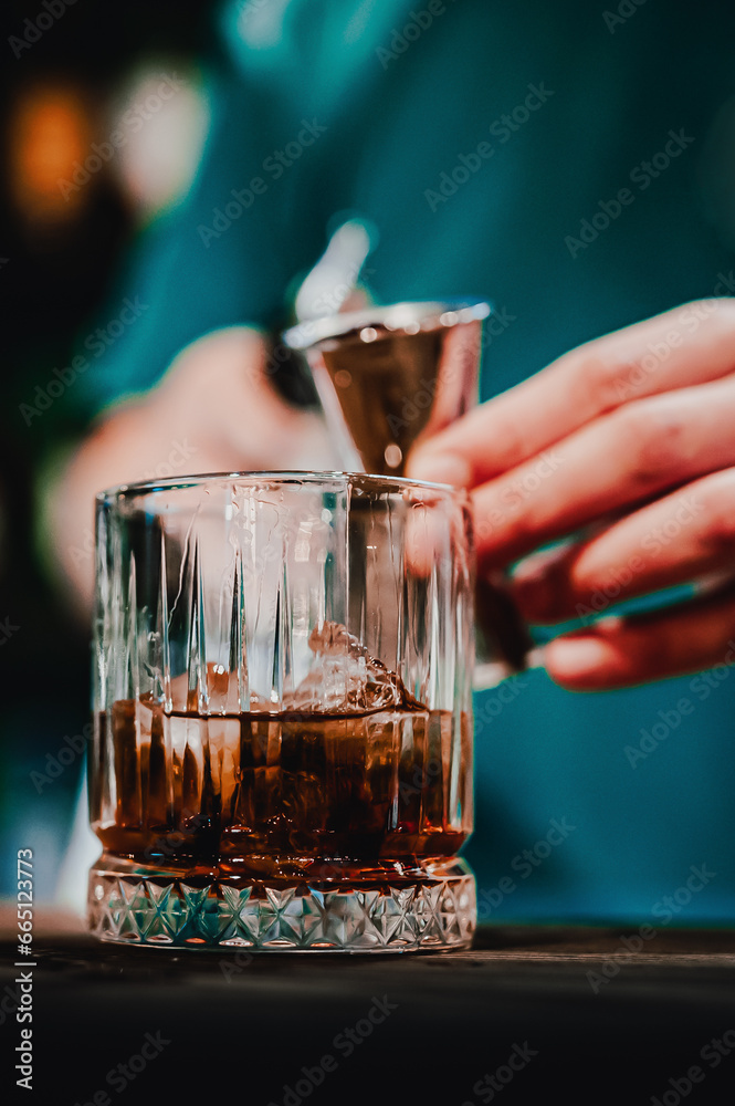 bartender hand making negroni cocktail
