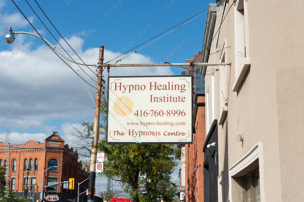exterior building and projecting sign of Hypno Healing Institute, a