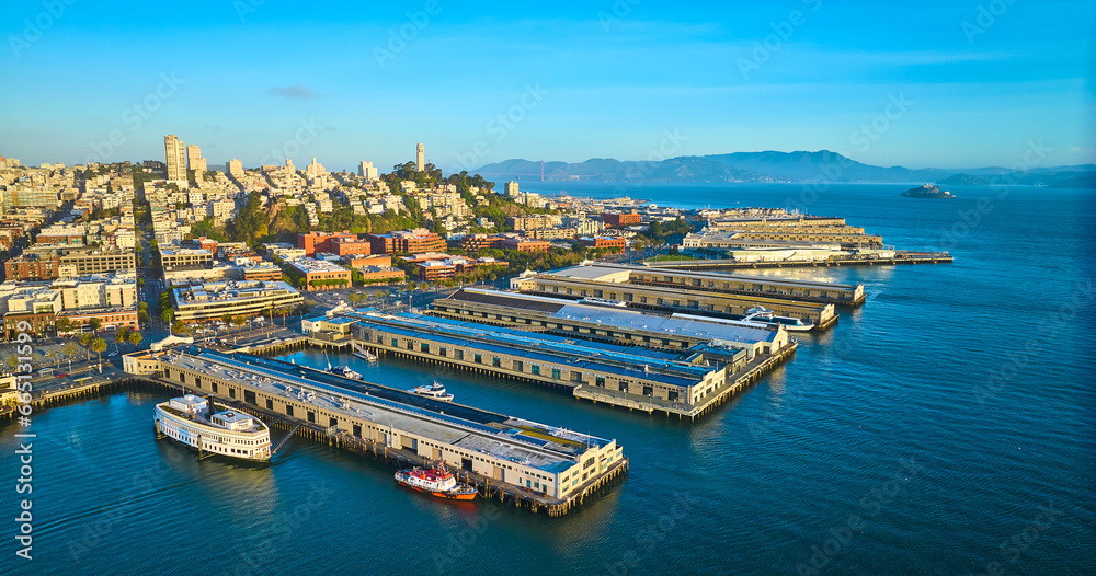 Sunrise aerial San Francisco piers with Coit Tower and Alcatraz Island in distance