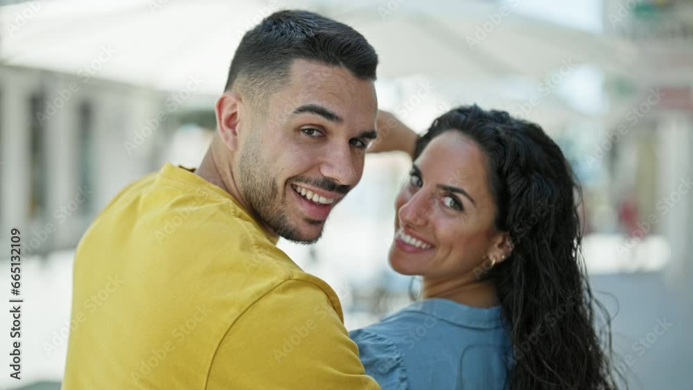 Man and woman couple smiling confident doing heart gesture at street Man and woman couple smiling confident doing heart gesture at street