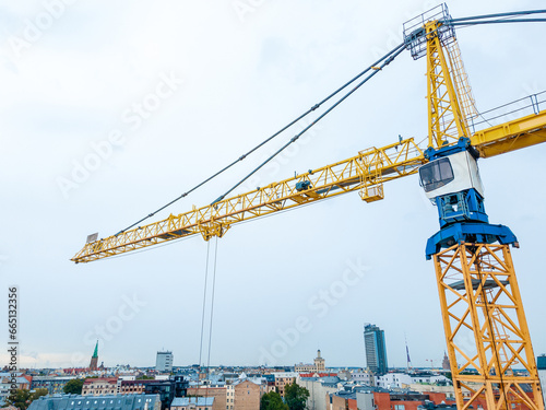 Yellow construction tower crane at a construction site