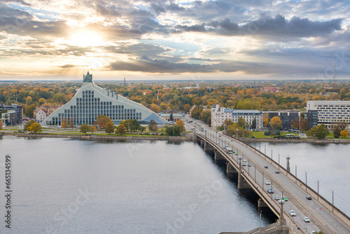 Panoramic view with Akmens Bridge over Daugava River and National Library of Latvia in Riga at sunset in autumn