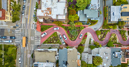 Straight down view Lombard Street top of hill with cars driving down red brick road aerial