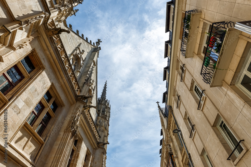 Low angle view of historical buildings against blue sky in Rouen, Normandy, France.