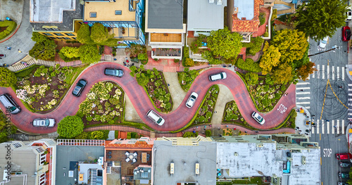 Straight down shot over Lombard Street with cars and road running horizontally through aerial photo