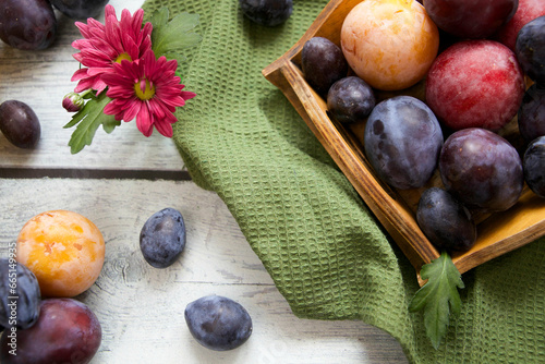 Fototapeta Naklejka Na Ścianę i Meble -  Sweet, ripe plums on a rustic wooden tray