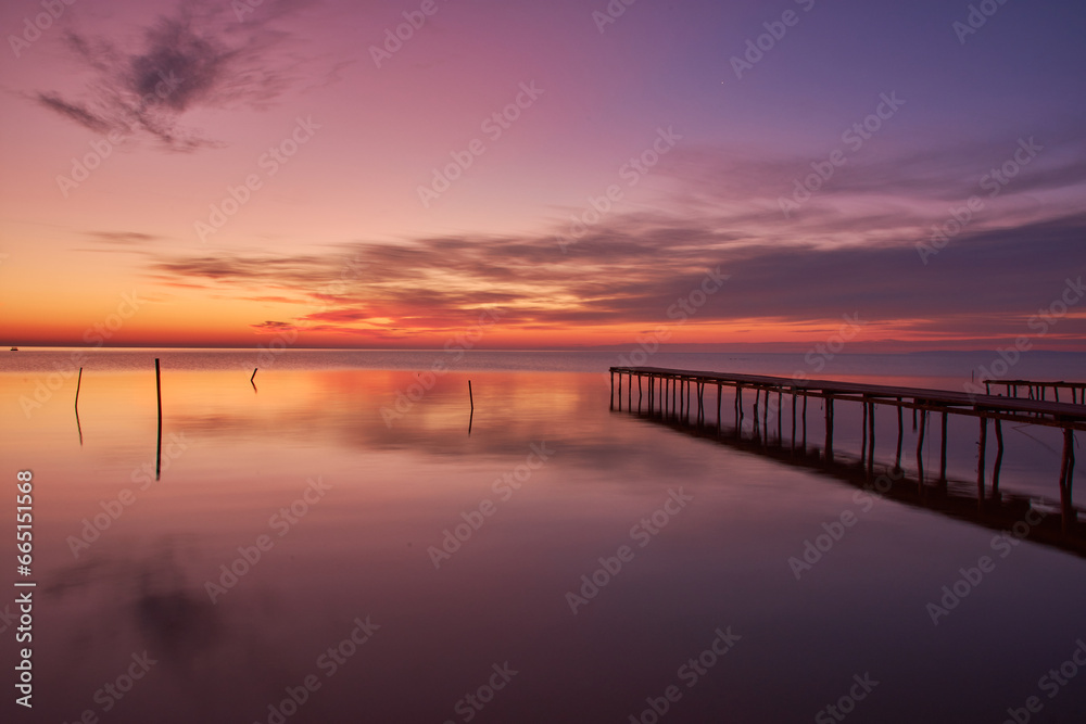 pontoon at sunrise on the lake