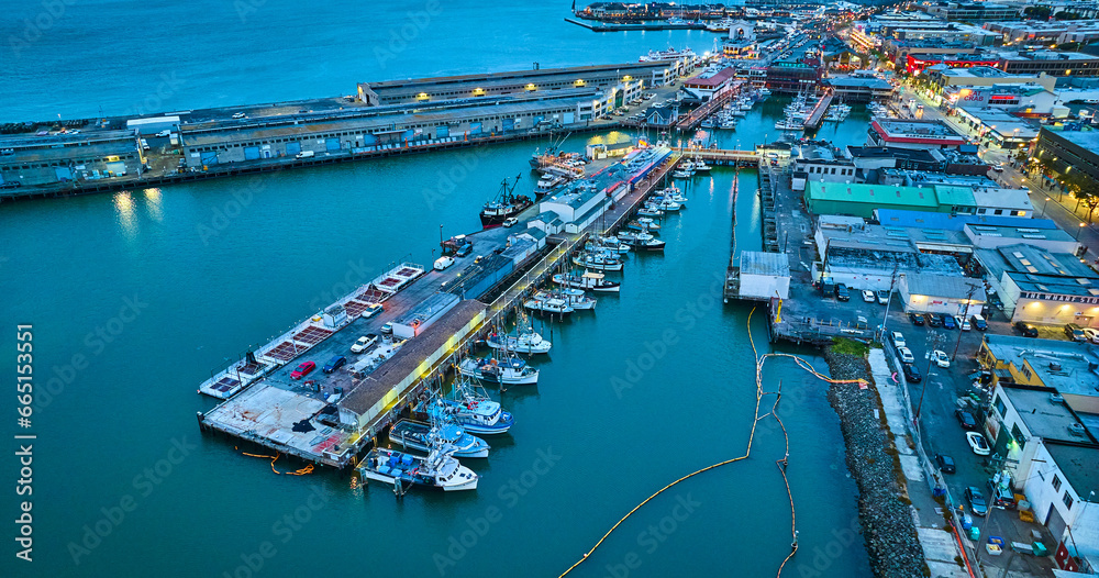 Aerial over Fishermans Wharf and Pier 39 at dusk with yellow street lights on