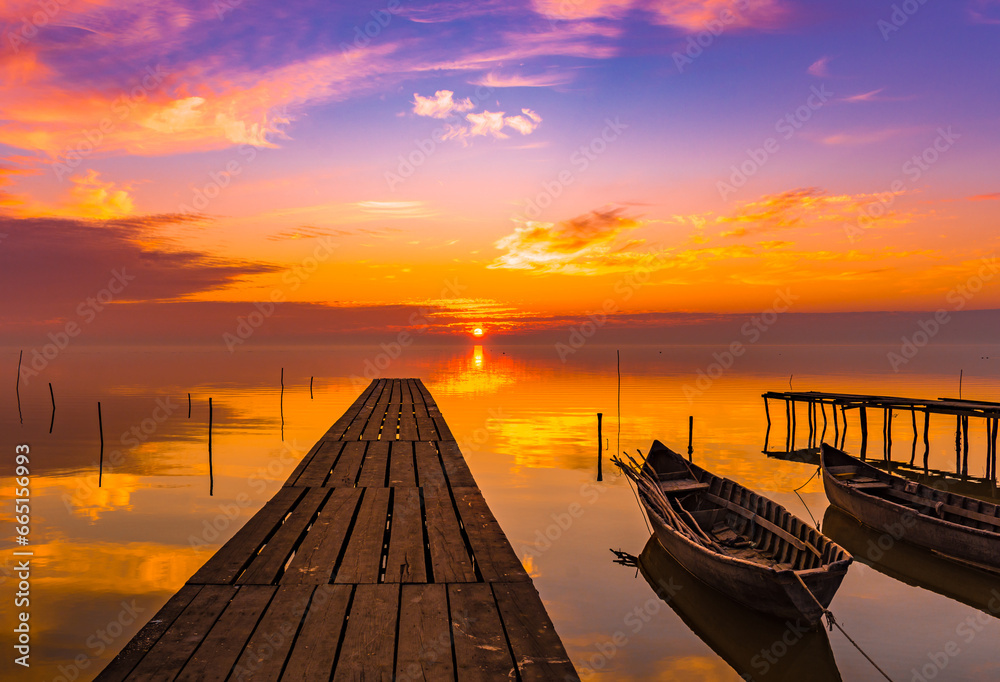 sunrise with boats on the lake